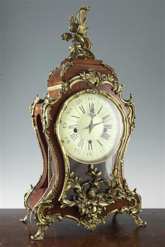 A Louis XV style brass mounted rosewood chiming mantel clock, 28in.